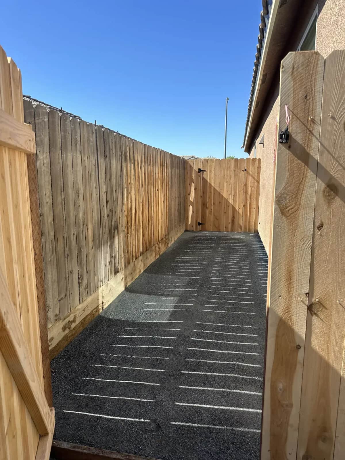 DG side yard with new wood fence