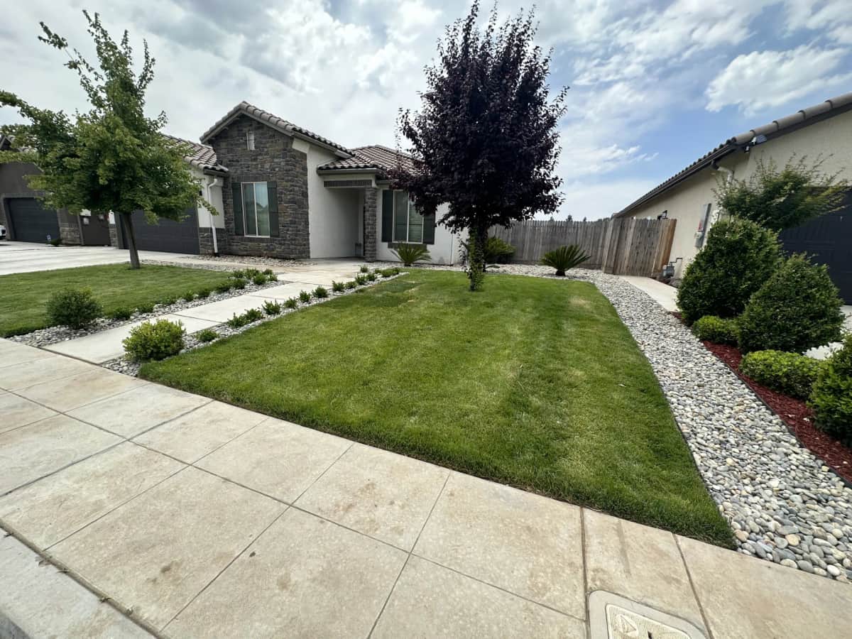 Stone home front yard with rock — street view