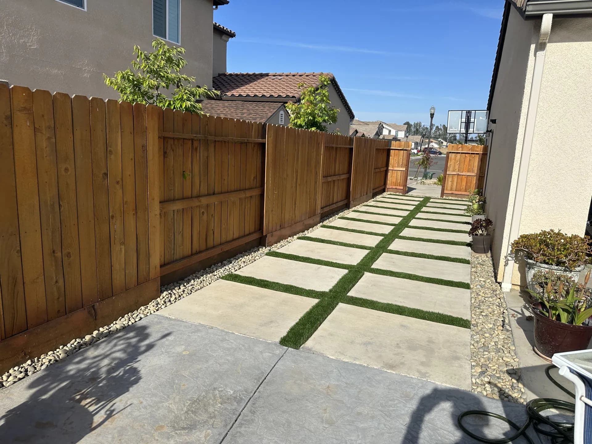 Side yard artificial grass with paver walkway