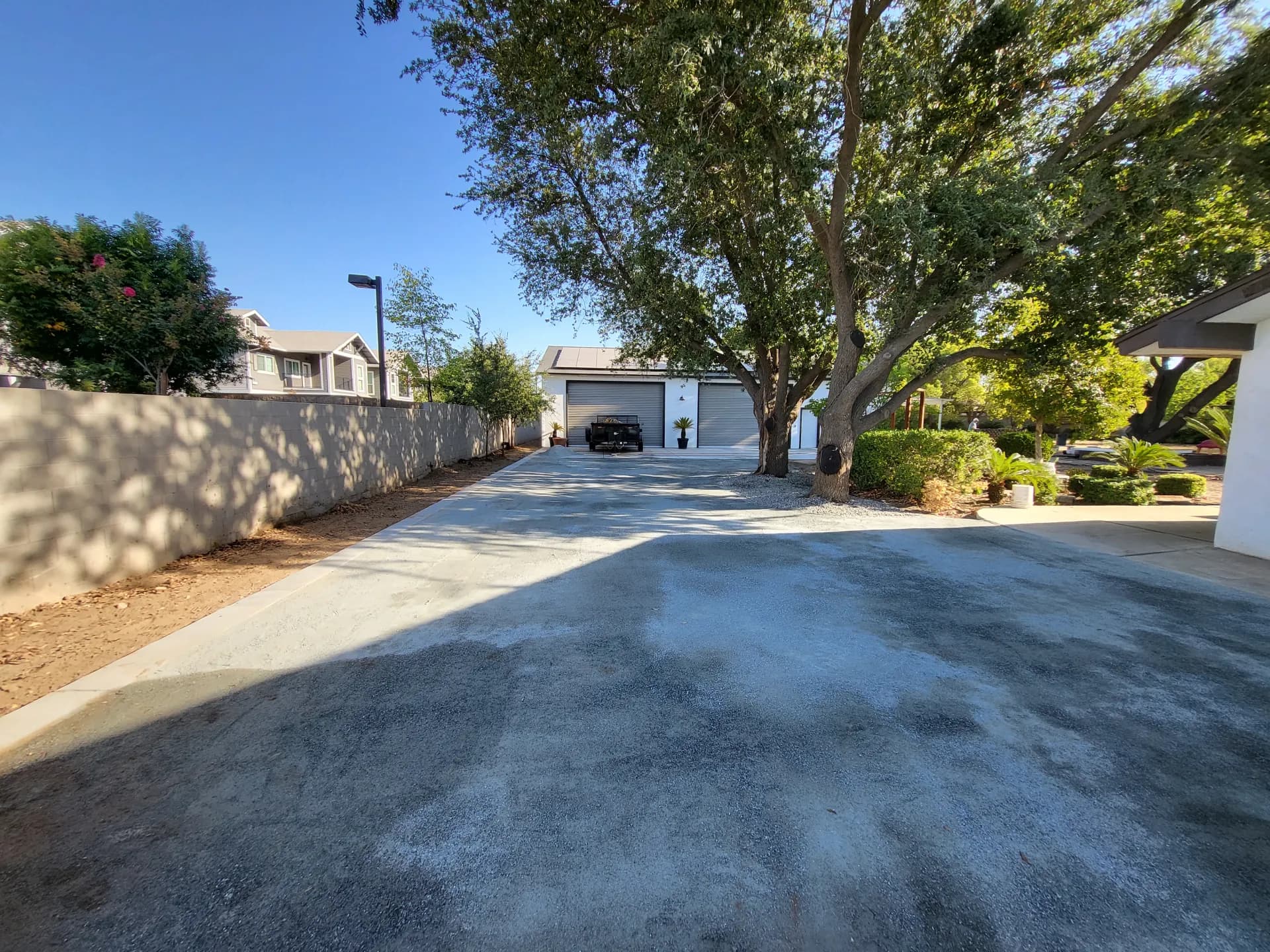 DG driveway and side yard — wide view