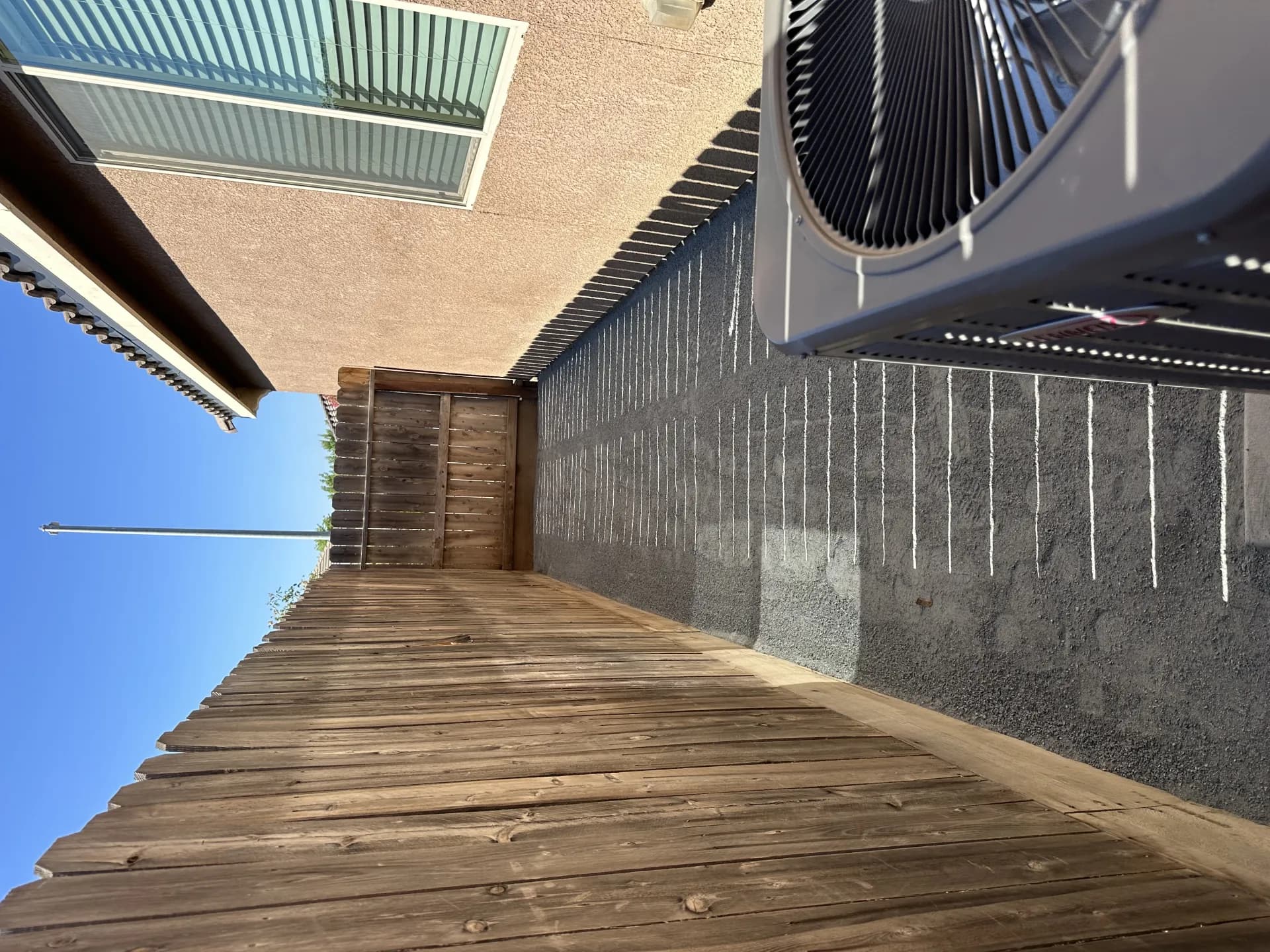 DG side yard with wood fence and AC unit