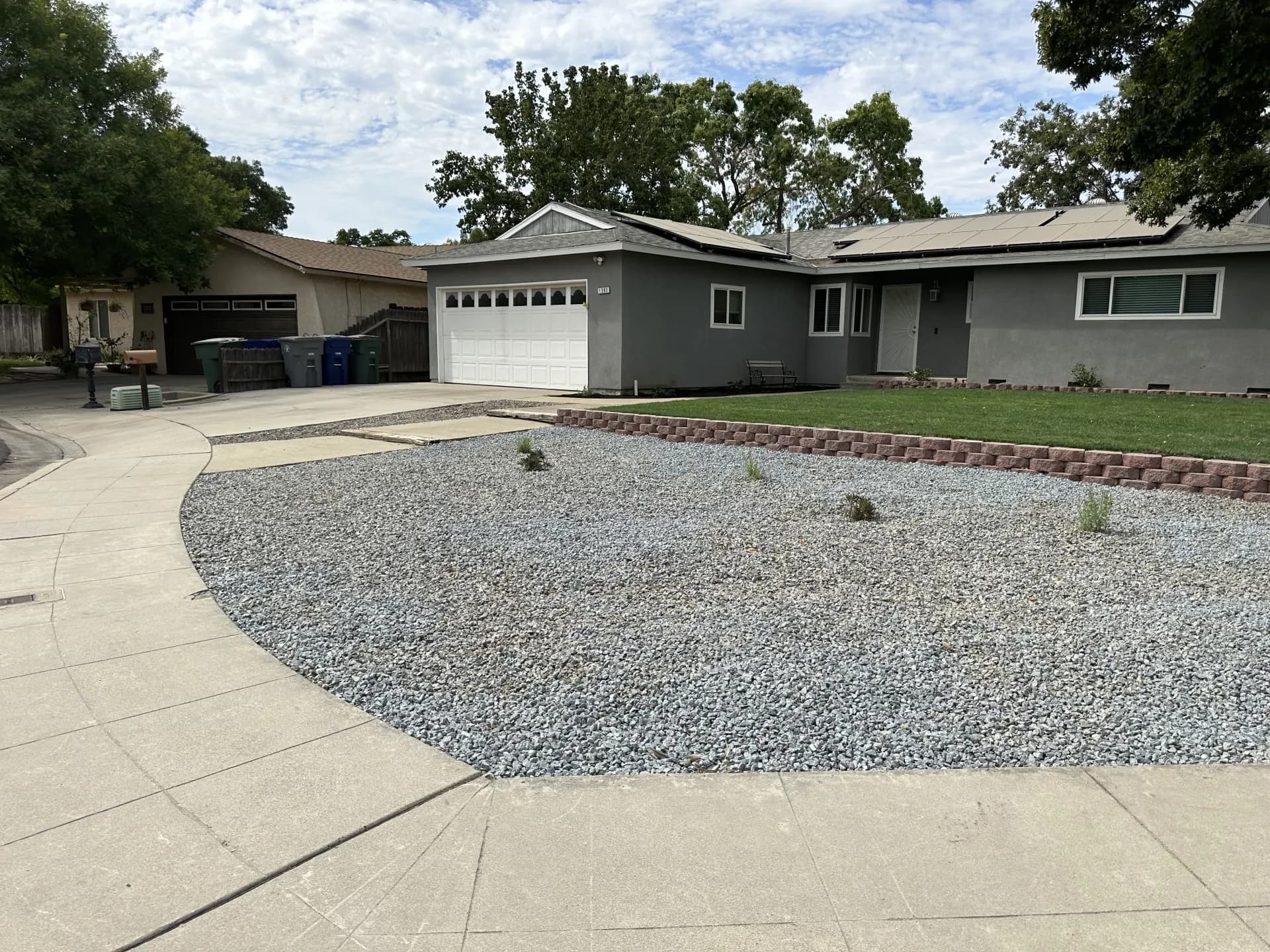 Front yard retaining wall with lawn over rock