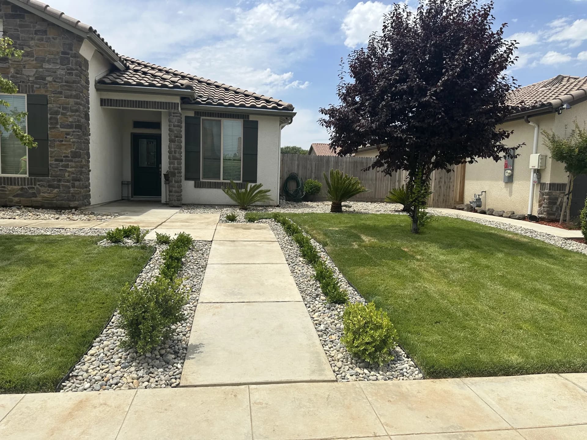 Stone home front yard with river rock