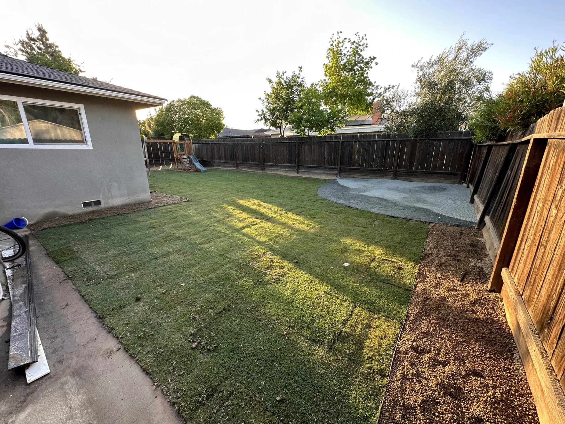 Large sod backyard with play structure