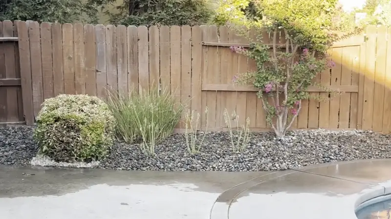 Backyard pool area with crushed rock