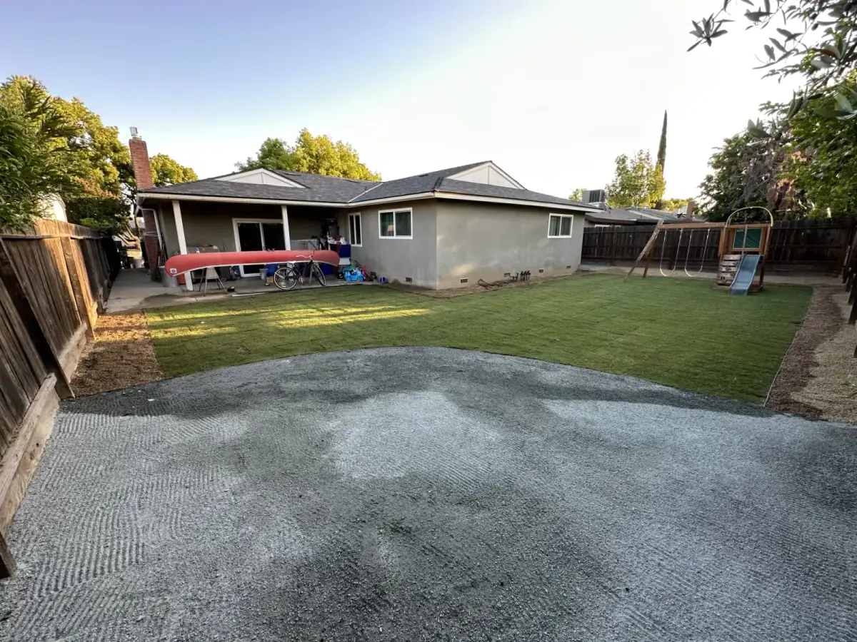 Large backyard with combined sod lawn and gravel zones