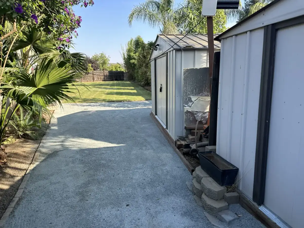 Side yard with decomposed granite pathway leading to a shed