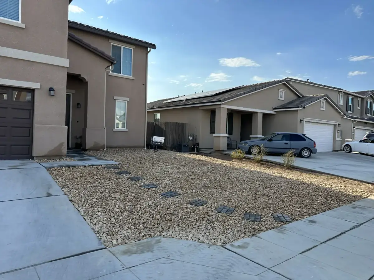 Front yard with stepping stones set into gravel and drought-tolerant plants